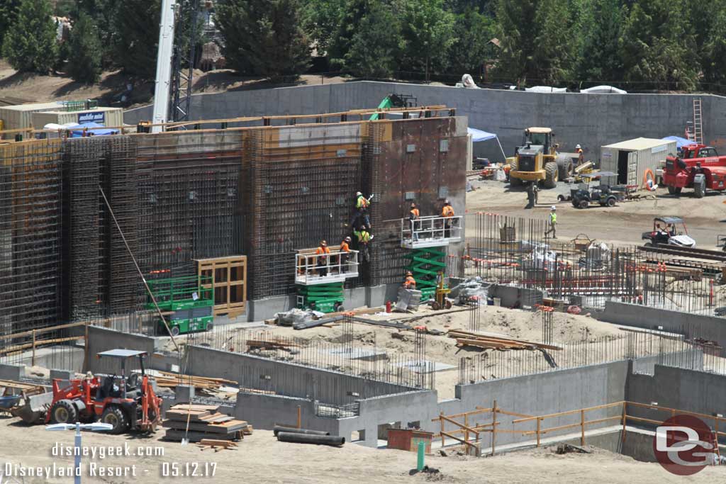 5.12.17 - Crews working on this wall. There appears to be two doors/walkways in it.  One is visible on the left.  The other is just to the right of that behind the lift.
