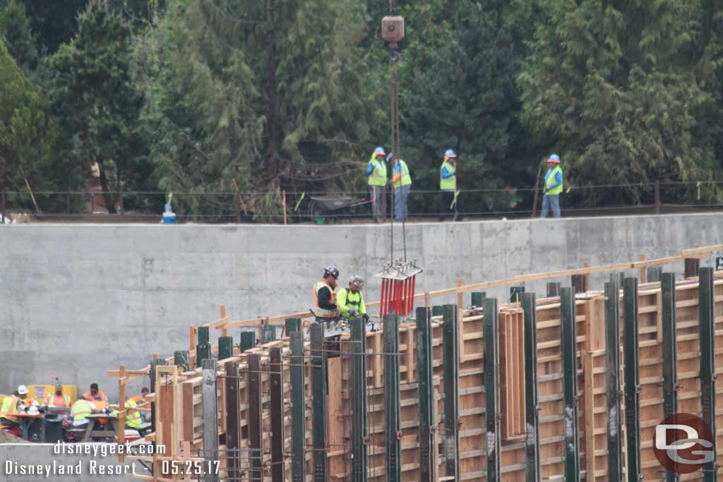 5.25.17 - Crews are lowering what looks to be bolts into the wall structure.  Most likely where steel will attach for the upper floor or roof.