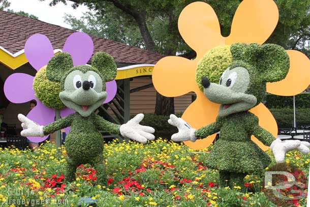 Mickey and Minnie topiaries acting as an advertisement for the Epcot International Flower & Garden Festival.