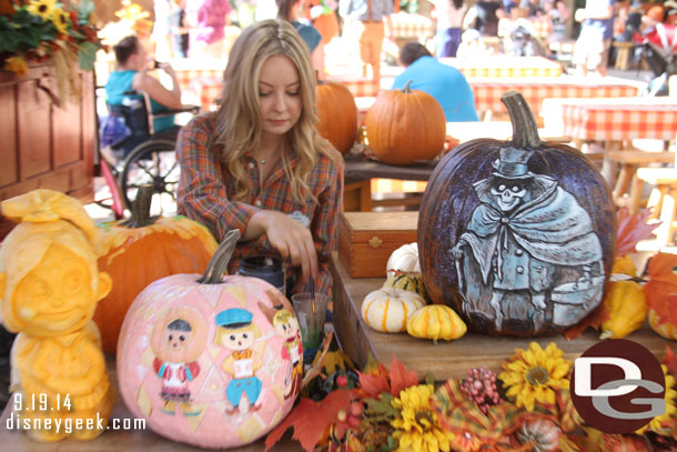 Bridget McCarty, one of the pumpkin carvers, at work on her next creation.