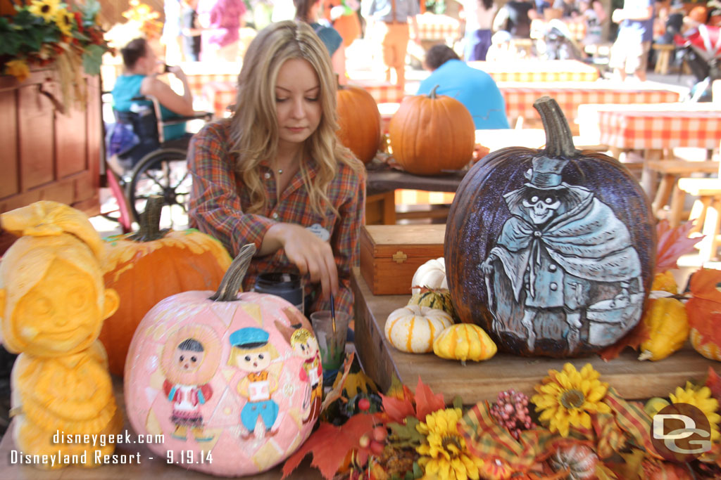 Bridget McCarty, one of the pumpkin carvers, at work on her next creation.