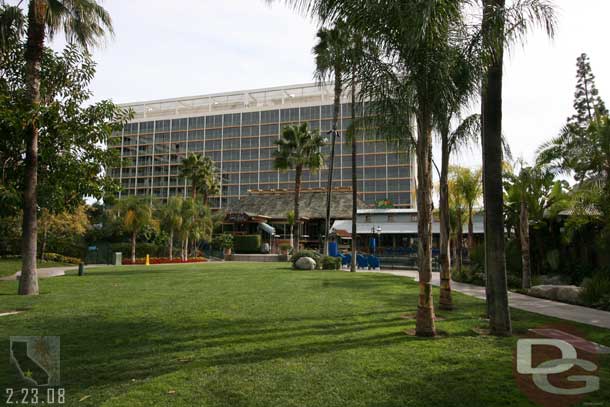 Looking across the grass(which acording to the map is the Never Land Glen) at the Dreams Tower, the pool is on the left, and Downtown Disney is beyond that tower