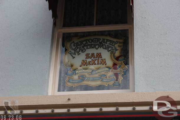 Location: Main Street Photo Supply <BR>
Inscription: Cartography Masterworks  Sam McKim  Map Maker to the Kingdom  Theres Magic in the Details<BR>
Information:  Sam McKim - Helped design Main Street and Frontierland (as well as Fun Maps) - added in mid-2006.