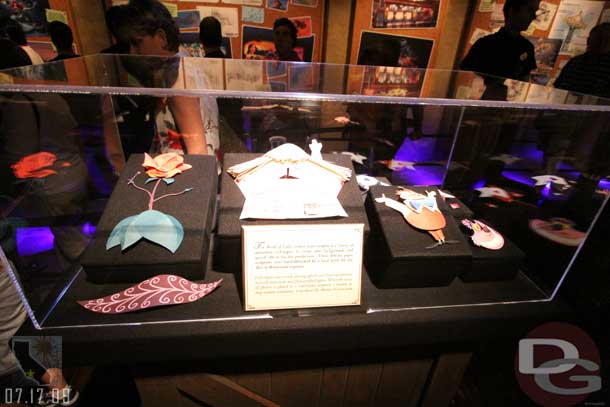 7.17.09 - The display case that had the Midway Mania attraction vehicle now has some of the Alice in Wonderland stop motion paper cutouts