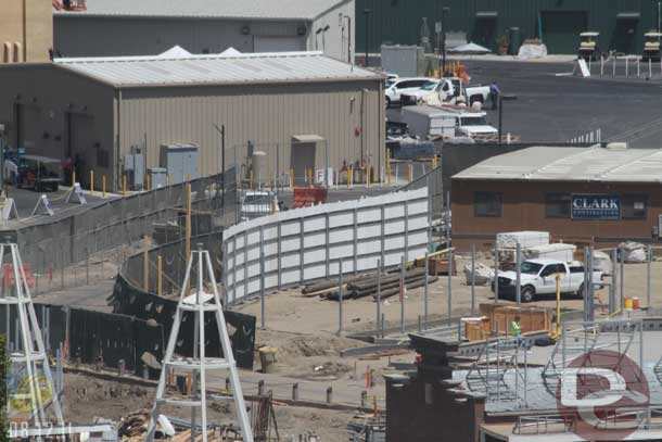 08.12.11 - A very tall wall is going in along the road/walkway.  Looks like it will hide the backstage area behind the Flying Tires.