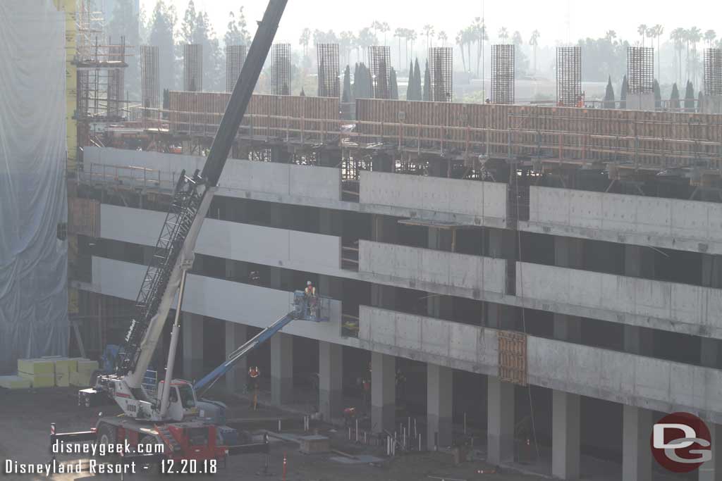 12.20.18 - Crews painting/sealing the side of the structure facing the tram stop. 