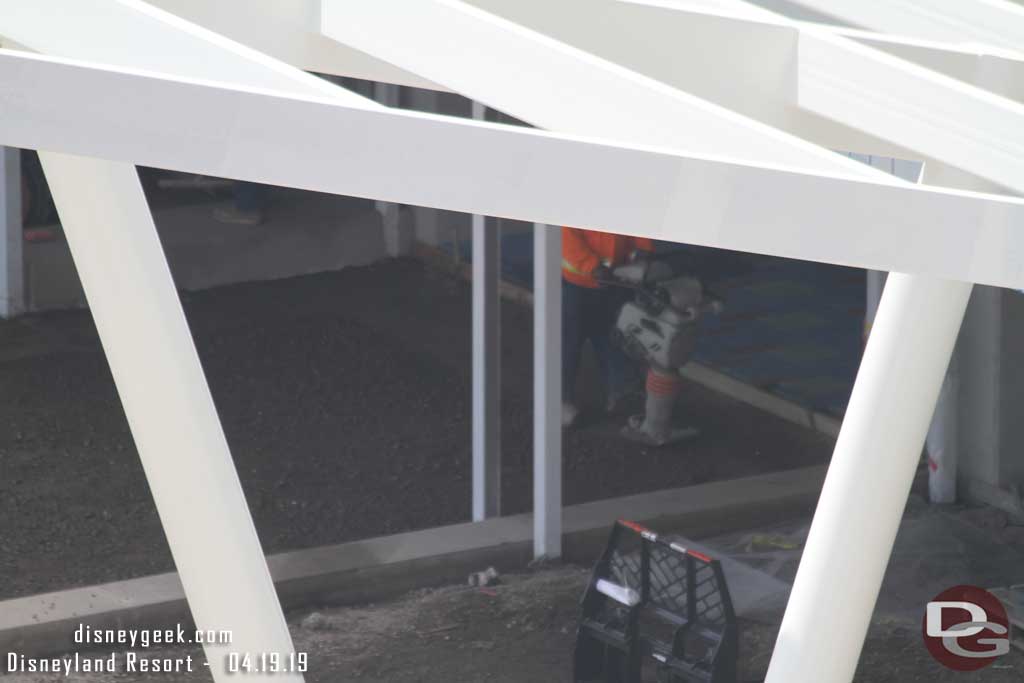 04.19.19 - Compacting the base material for the pavers.  Notice beyond the worker it appears pavers have been installed in the garage already.