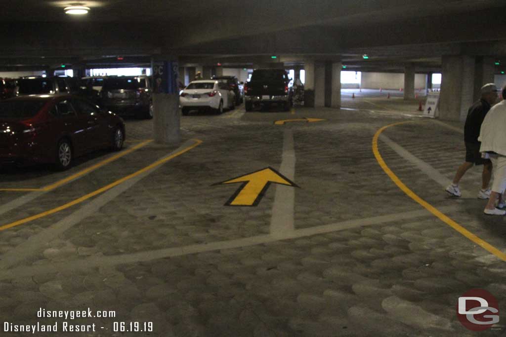 06.19.19 - New driveways are marked inside Mickey and Friends to guide cars exiting from the other structure.  I am standing in the middle of the connection lane.  You can see the new lane stripped through the first aisle and you turn on the second to avoid the job by the elevator/escalators.