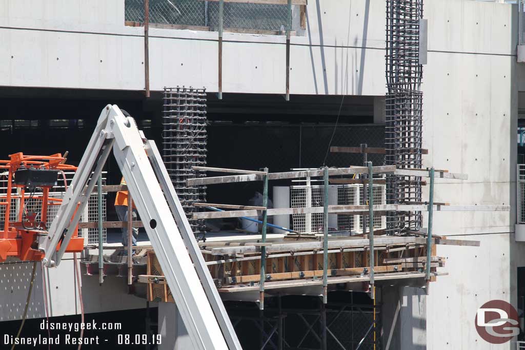08.09.19 - A worker working on recently poured concrete on the 5th floor span.