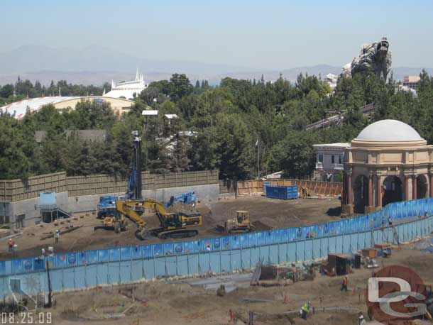 8.25.09 - They are driving what appears to be steel beams for a retaining wall into the ground.