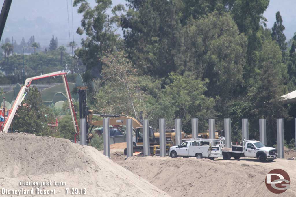 7.29.16 - A new beam being lowered into a hole and concrete pumped in.