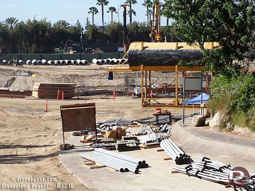 8.12.16 - Still a lot of conduit and pipes waiting to be installed, beyond the water tank you can see the new retaining wall for the far bank of the river taking shape.