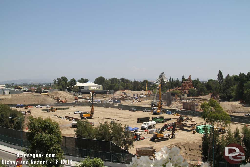 8.12.16 - Swinging back to the near lot now.  More i-beams are in the ground in the middle portion.  In the foreground is a staging area for continued utility work.