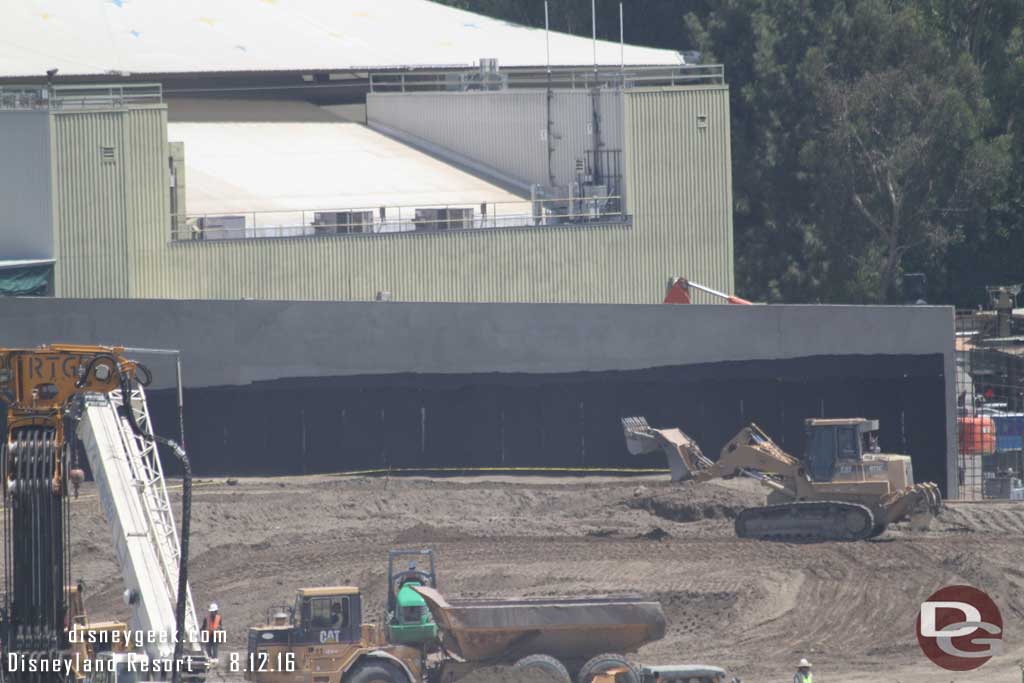 8.12.16 - Here you can see them spreading out and compacting dirt along the new wall.  Guessing it will eventually be built up to the cover most of the black.