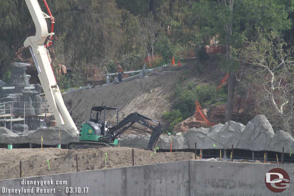 3.10.17 - Steel still laying on the island in the background.  In the foreground a piece of equipment digging a hole, guessing for a tree.