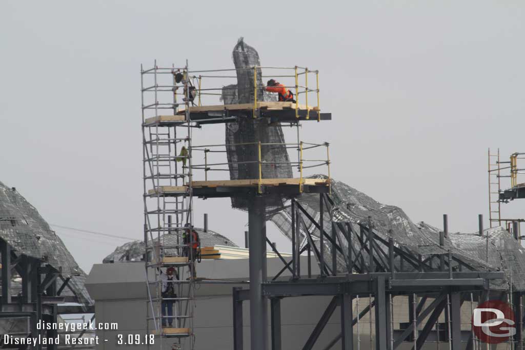 03.09.18 - One crew working on the rock formation and another below moving scaffolding pieces.