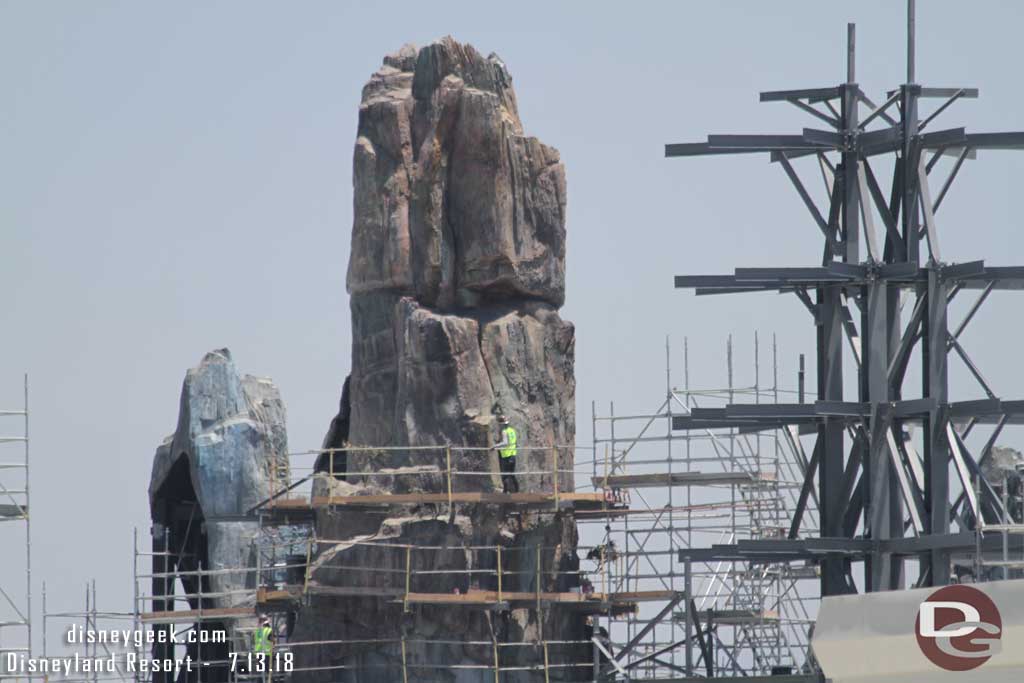07.13.18 - The tallest original spire is slowly be revealed as scaffolding and steel toothpicks are removed.  The worker helps with scale.