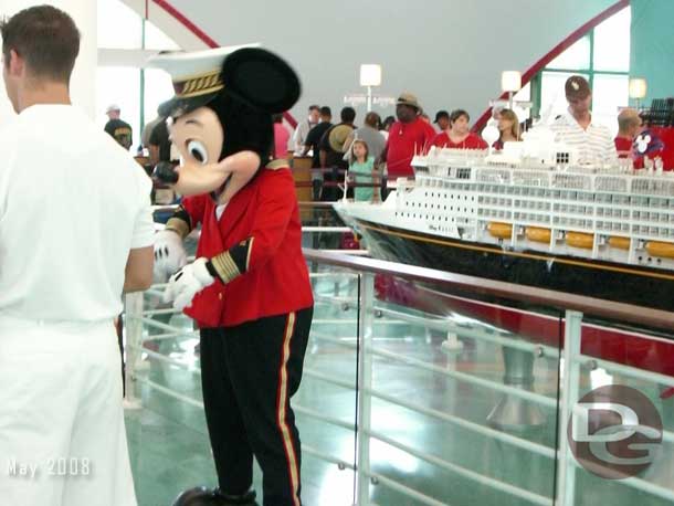 Mickey greeting guests in the cruise terminal