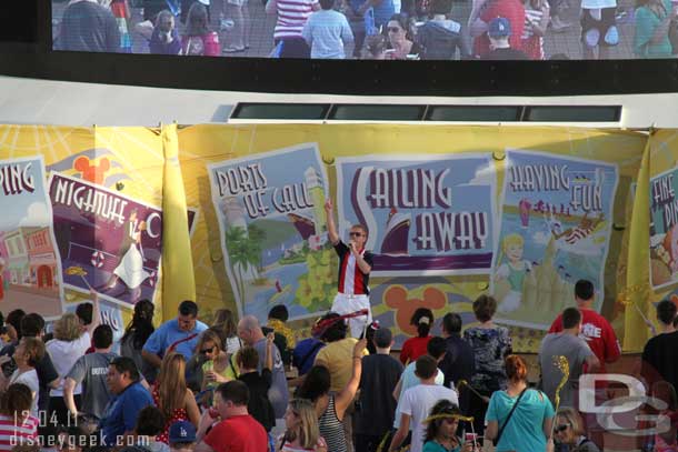 A member of the cruise staff takes to the stage.