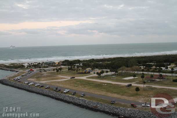 Cars lined up in the park.  Some fishing, but others there just to watch the parade of cruise ships heading out.