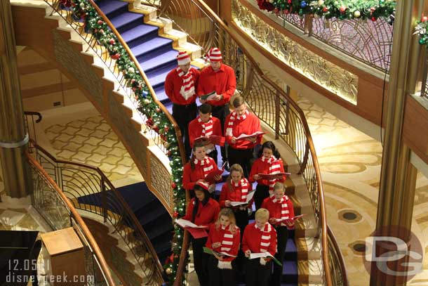 A cast member choir caroling in the lobby.