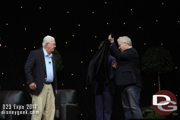 He presented a gift from the Oriental Land Company (the team that runs Tokyo Disney Resort) to Wayne.