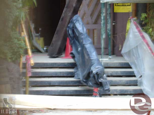 A look through a crack in the fence at the Tiki Room work