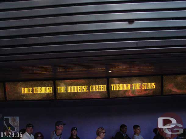 A sign behind Space Mountains fastpass distribution area