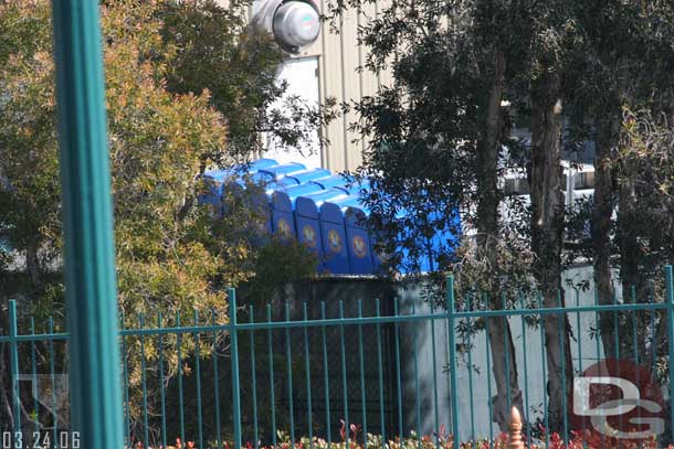 Trash cans lined up and ready to go to the park.