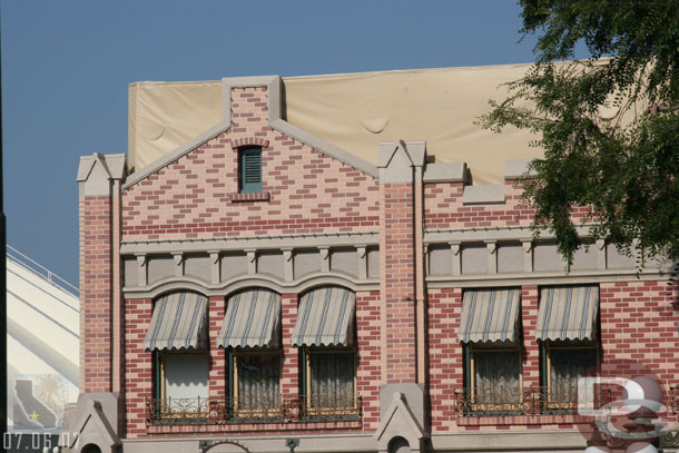 The tarps are still up on the roof of hat store