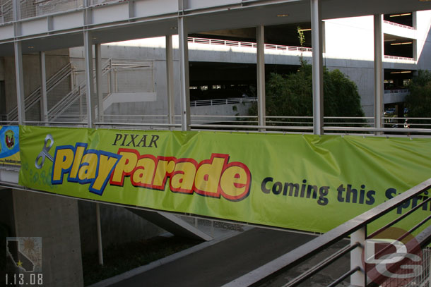 At the Mickey and Friends garage a sign is up for the new parade that premiers in March