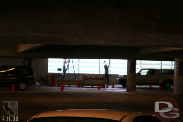 They were replacing or cleaning (I could not tell) the glass on the parking structure far side