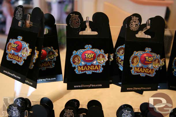 The pins say Toy Story Mania (as does all the merchandise, but the main sign says Toy Story Midway Mania as does the coming soon blurb in the guidemap).