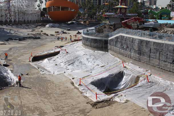 Some holes are now dug for the new boardwalk/viewing area for the World of Color show.  Looking at the concept art the holes may be where the light/sound tower equipment will go.