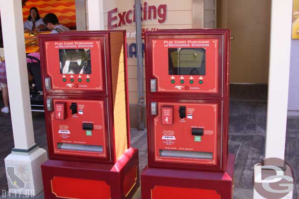 You purchase a game card from a kiosk (cash is no longer accepted at the games themselves)