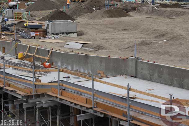 Concrete has now been poured in most of it.  Also under the boards are steps not a ramp (saw that on another site, they were covered Friday though)