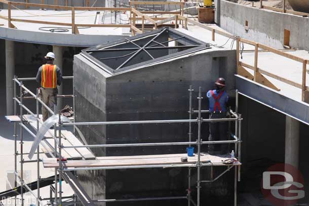 Scaffolding is up around much of the concrete work as the work to finish it (appears much of it will get rockwork)