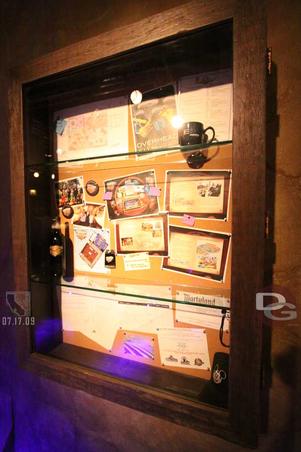 The display case at the end of the entrance hallway has info for the new website, the D23 expor, and other random items.