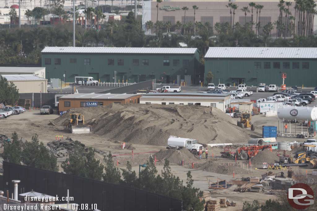 The mound of dirt is getting smaller.  Also the small part of asphalt that was left from the World of Color staging area looks to have been removed.