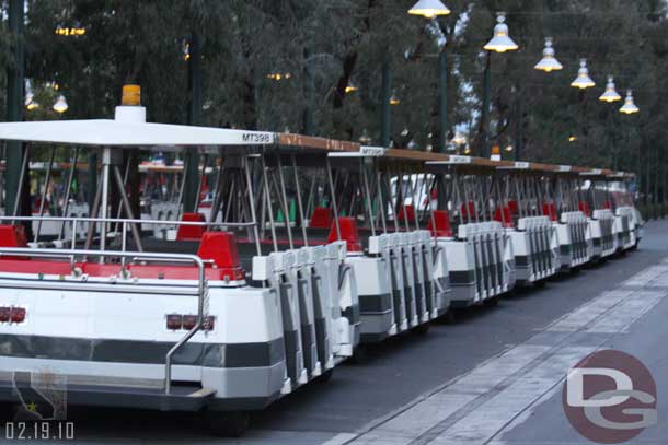 There were two trams with doors parked in the tram stop.