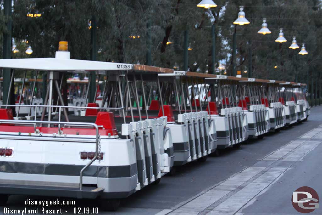 There were two trams with doors parked in the tram stop.