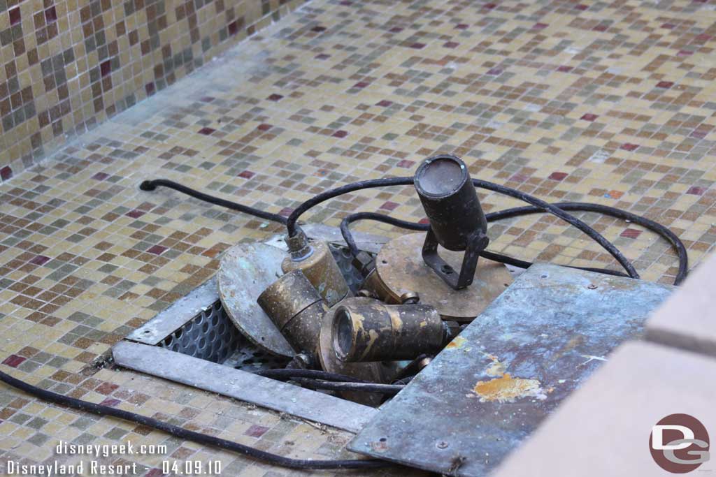 The water is out of the fountain near the restrooms, and the lights are all stacked up in the middle.