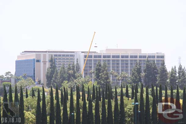 A crane lifting something to one of the Disneyland Hotel Towers