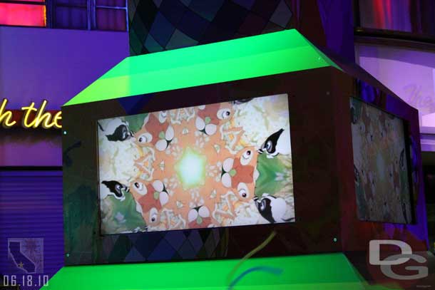 The screens show a mix of Disney and abstract film.