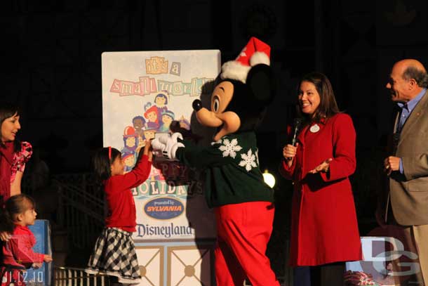 Adela and Mickey Mouse flipped the switch to turn on the lights.