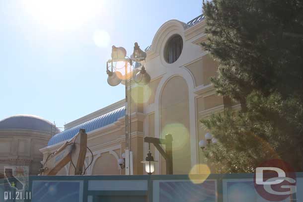 The blue roof is slowly making its way around.  In the foreground a large piece of equipment, looks like they are working on the walkway?