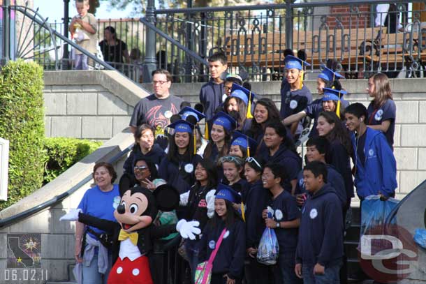 This was interesting.  We were walking through Town Square and heard a bunch of people yelling.  Seems this group was setting up for a picture and Mickey came out and was heading toward the flag pole area.  They were loud enough to draw his attention and he ran across the street for a quick picture with them.  Great moment!