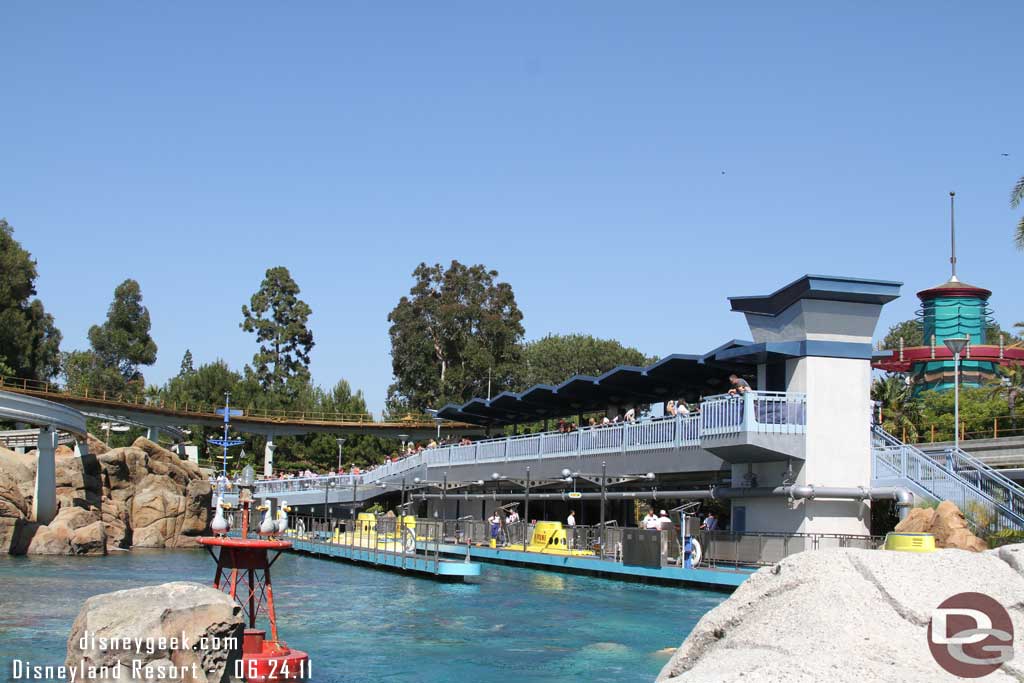 Notice the long monorail line.  One just left, the platform is full, and it stretches down the ramp and around the first turn.  This was partially due to only one monorail running (Blue). 