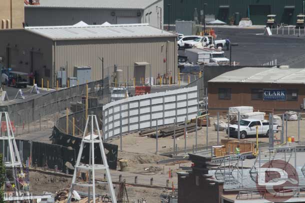 A large fence going up along the road/walkway that was put in.  Looks to be fore hiding the backstage areas behind the Flying Tires.