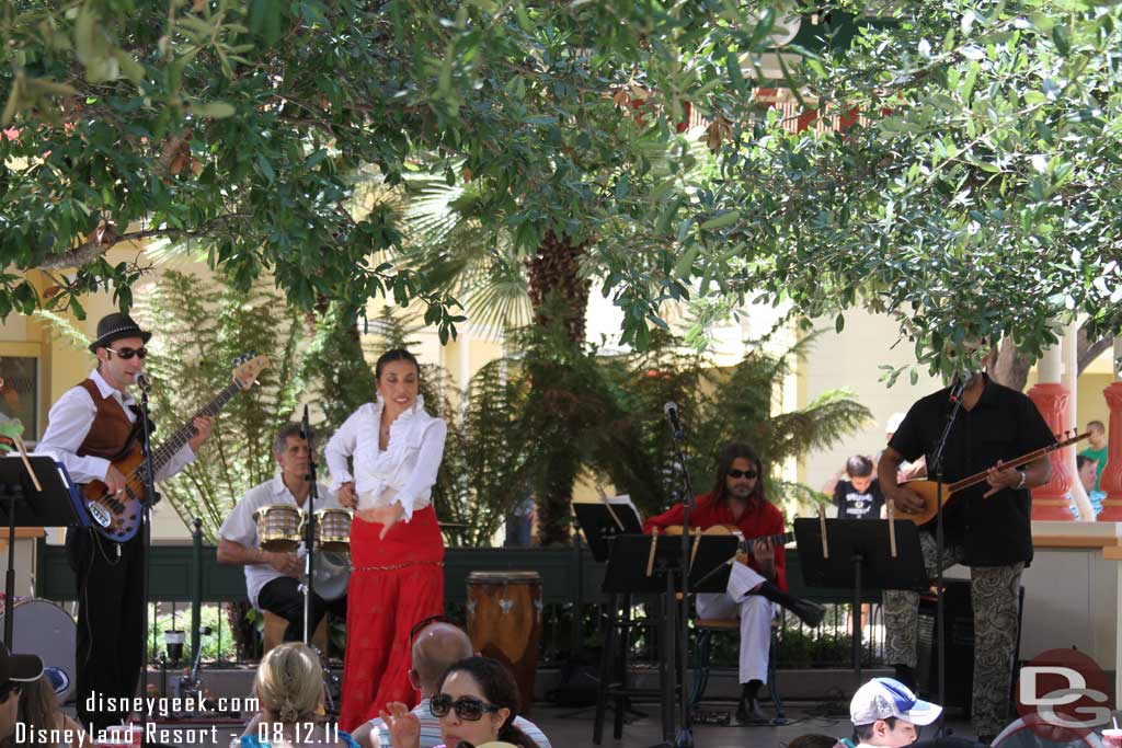 A group performing on the Paradise Gardens stage.